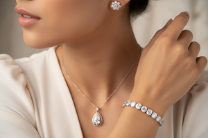a women wearing pendant 925 sterling silver with a tennis barcelet and studded earrings 